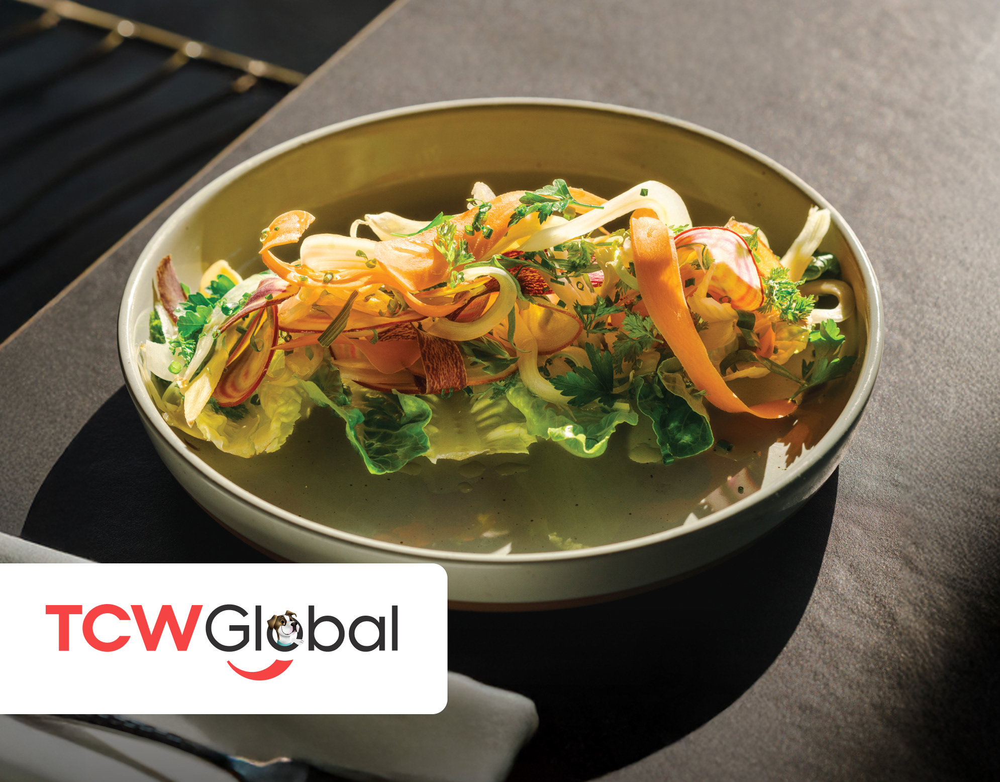 BoujieMana cover: overhead shot of a gourmet plated dish with citrus, herbs, and greens in a shallow broth