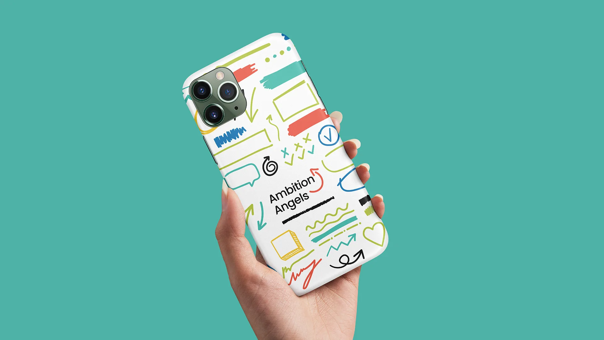 Hand holding a phone case featuring a colorful Ambition Angels doodle pattern with icons and the logo, teal background